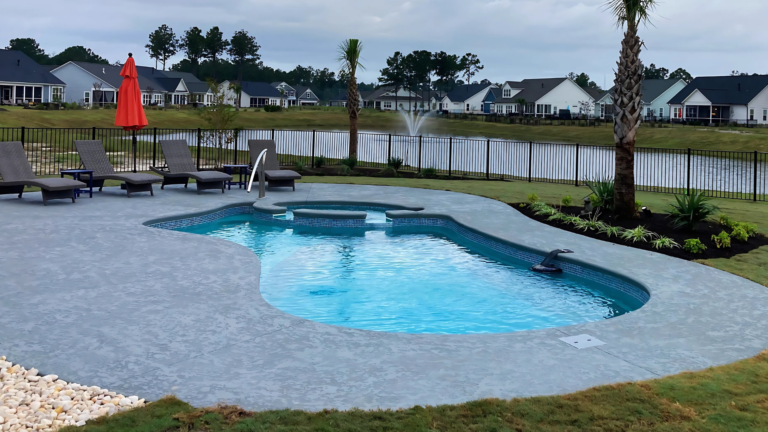 a backyard with a gunite pool and patio furniture