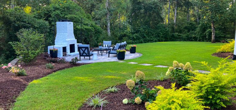 Expert Outdoor Design and Installation in Southeastern NC featuring a custom patio with a cozy fire pit, perfect for relaxing and entertaining.